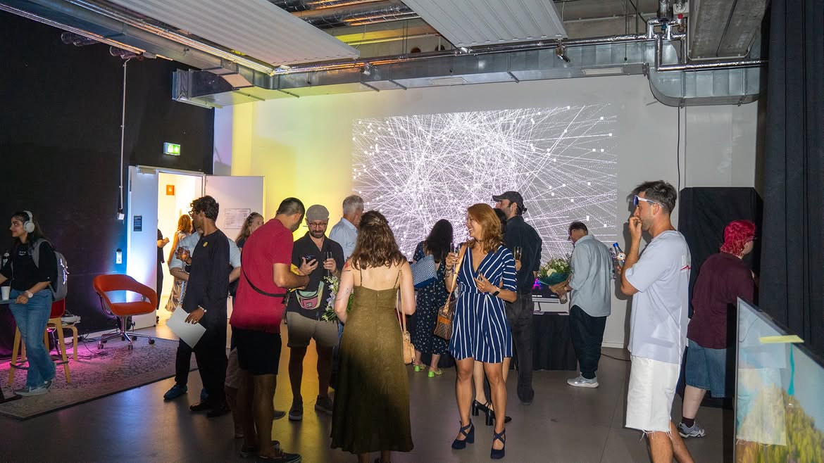 Large black and white generative network projection behind visitors in an exhibition room